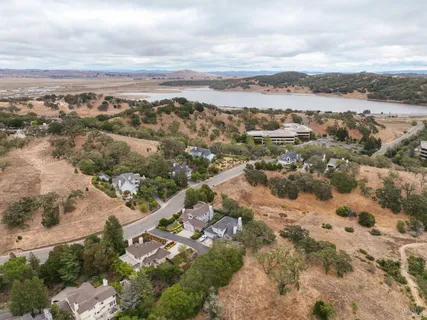 an aerial view of residential building with yard