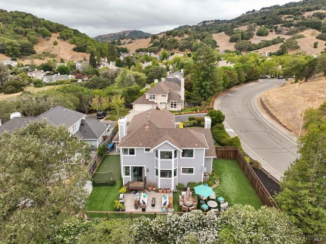 an aerial view of a house with a big yard