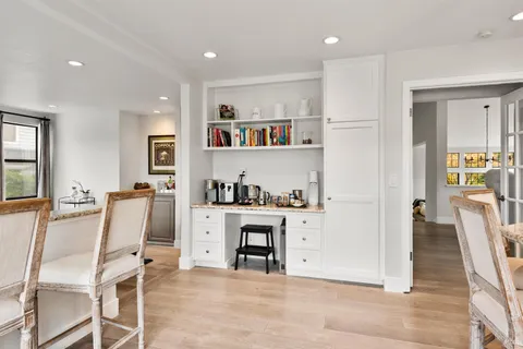 a view of kitchen with furniture and wooden floor