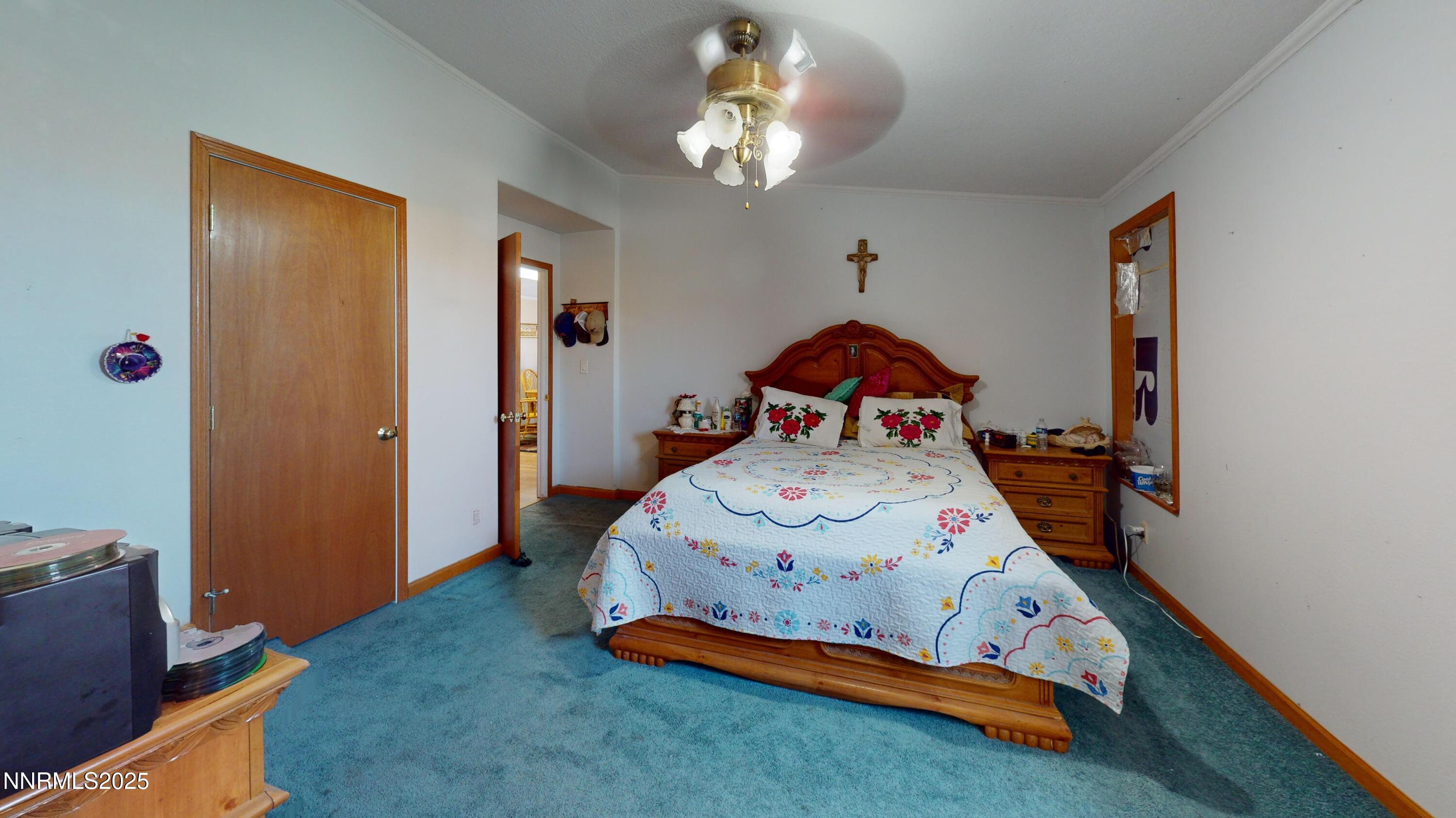 3400 Potbelly Road Winnemucca, NV 89445 - Photo 15 of 50 a bedroom with a bed and a chandelier