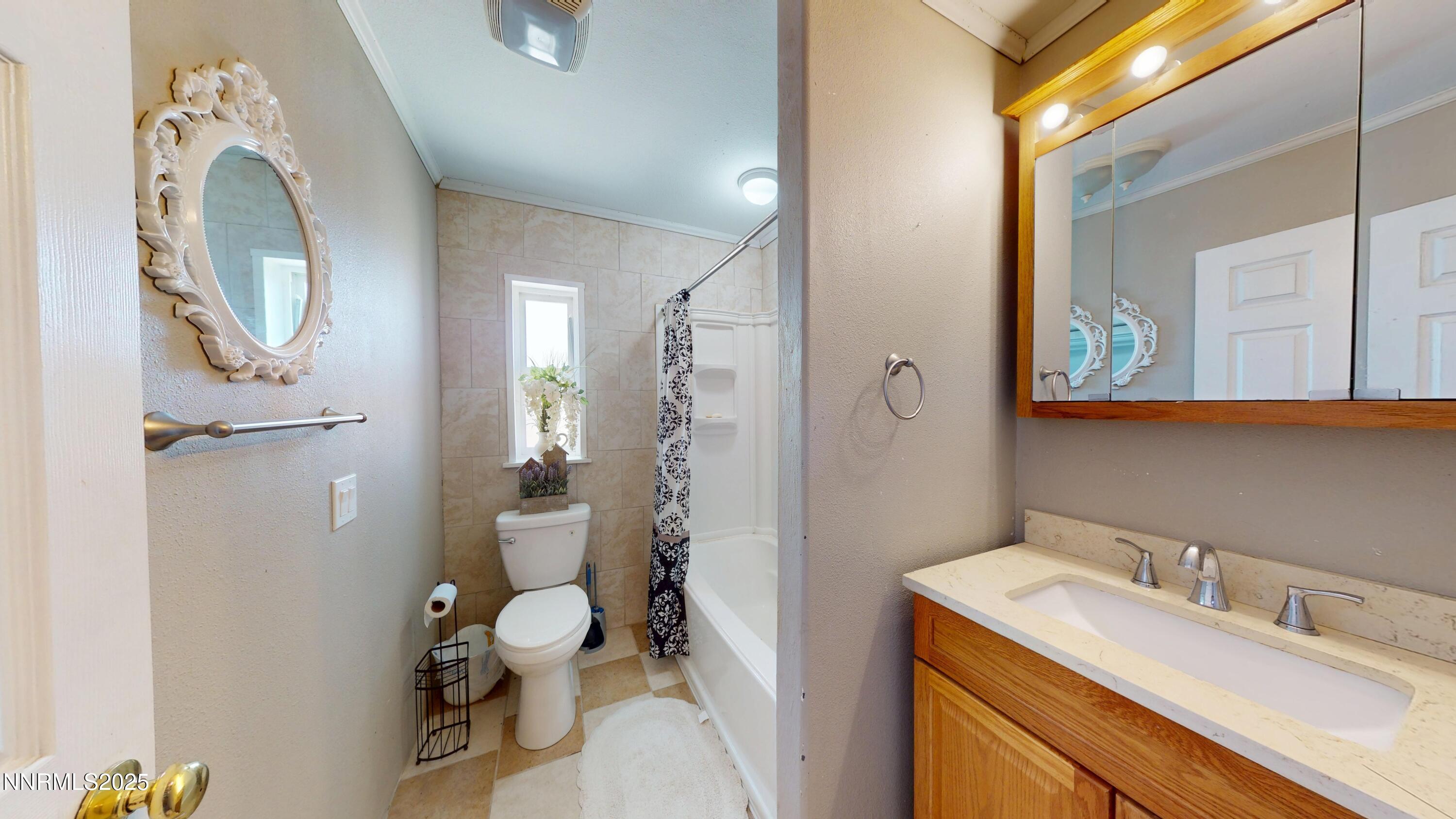 3400 Potbelly Road Winnemucca, NV 89445 - Photo 20 of 50 a bathroom with a granite countertop toilet sink and mirror