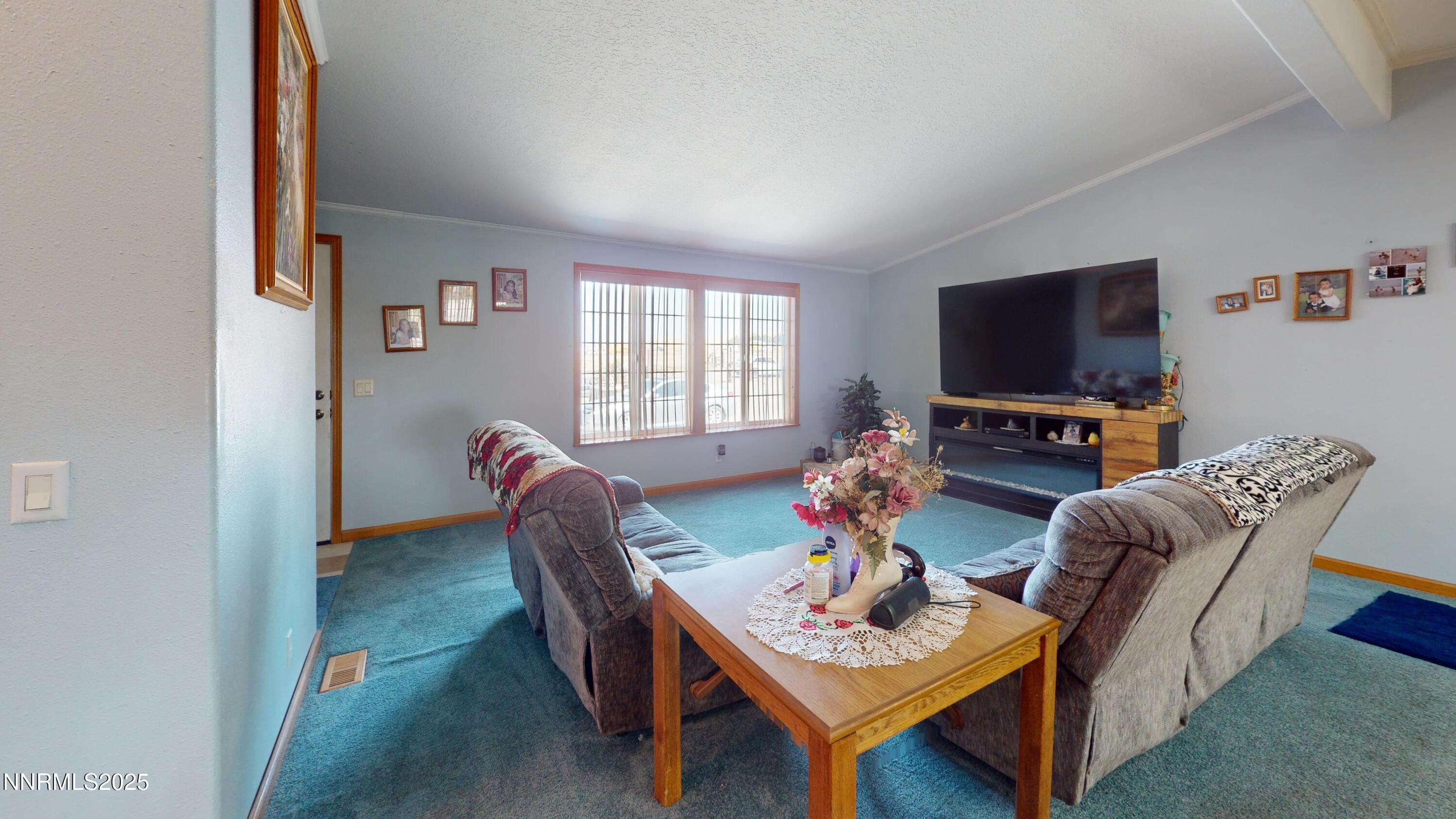 3400 Potbelly Road Winnemucca, NV 89445 - Photo 4 of 50 a living room with furniture a flat screen tv and a window