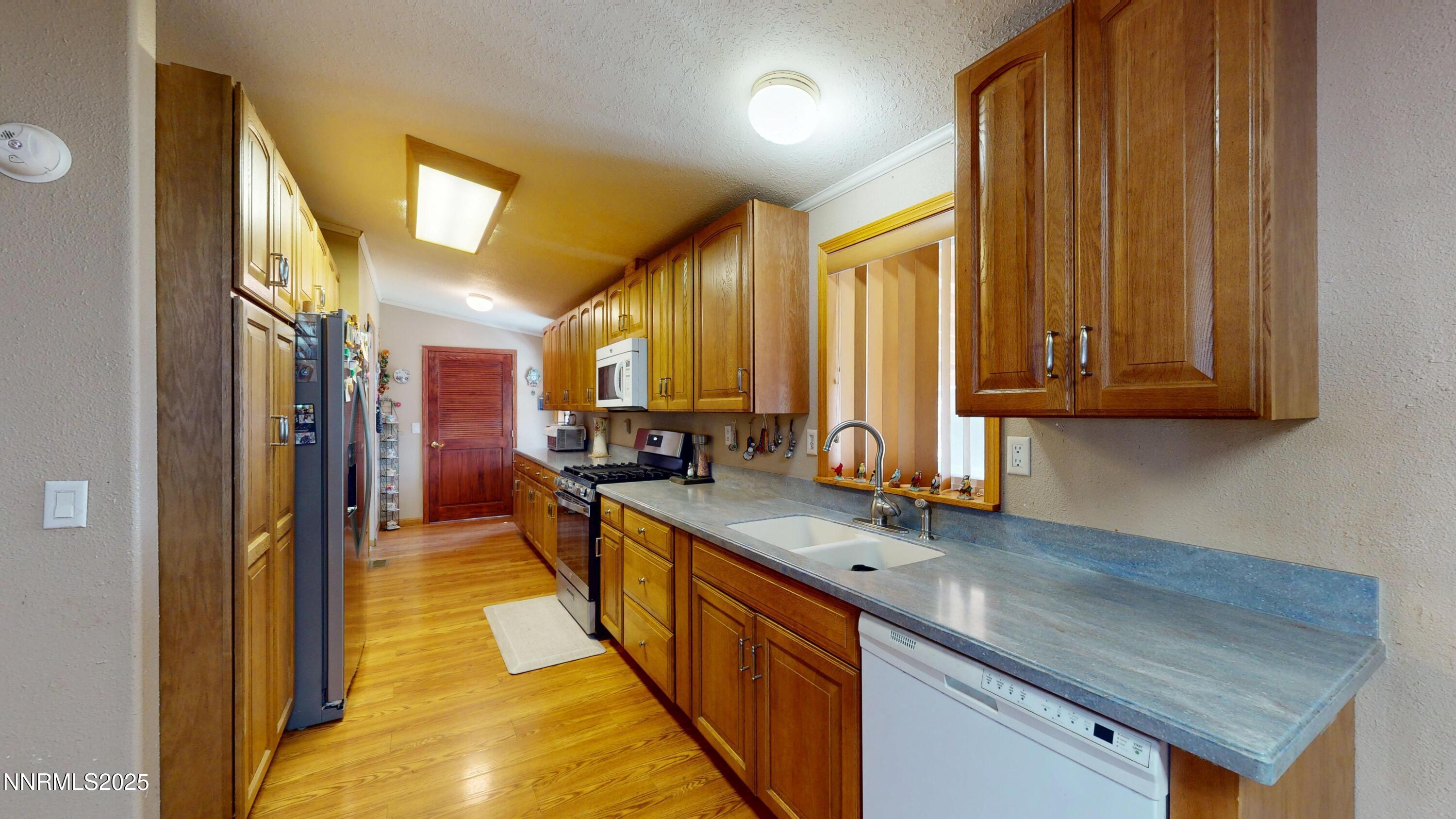 3400 Potbelly Road Winnemucca, NV 89445 - Photo 8 of 50 a view of a kitchen with stainless steel appliances granite countertop a sink and cabinets