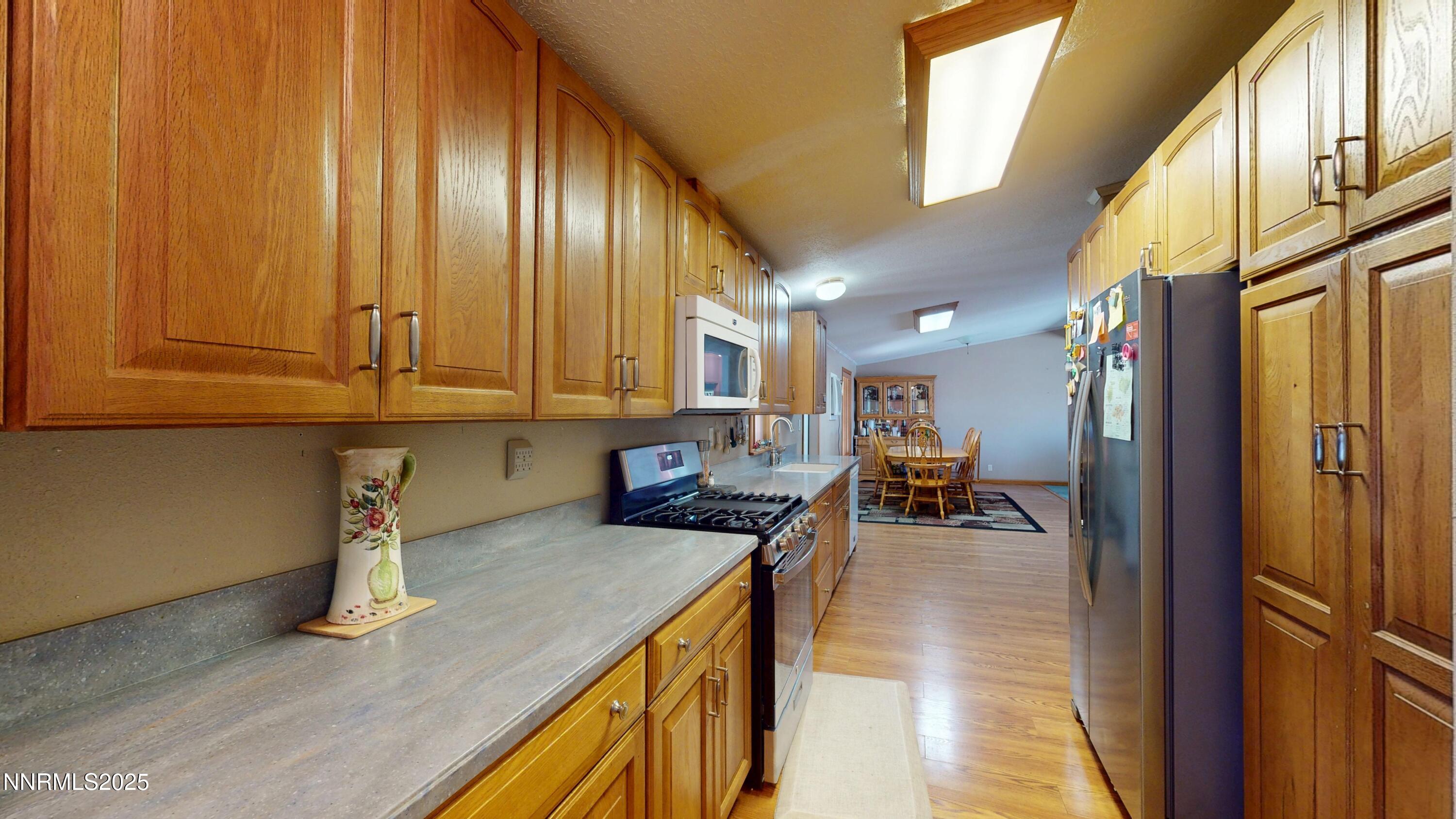3400 Potbelly Road Winnemucca, NV 89445 - Photo 10 of 50 a kitchen with stainless steel appliances granite countertop sink stove and cabinets