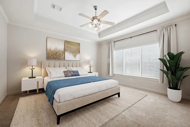 a spacious bedroom with a bed and a chandelier