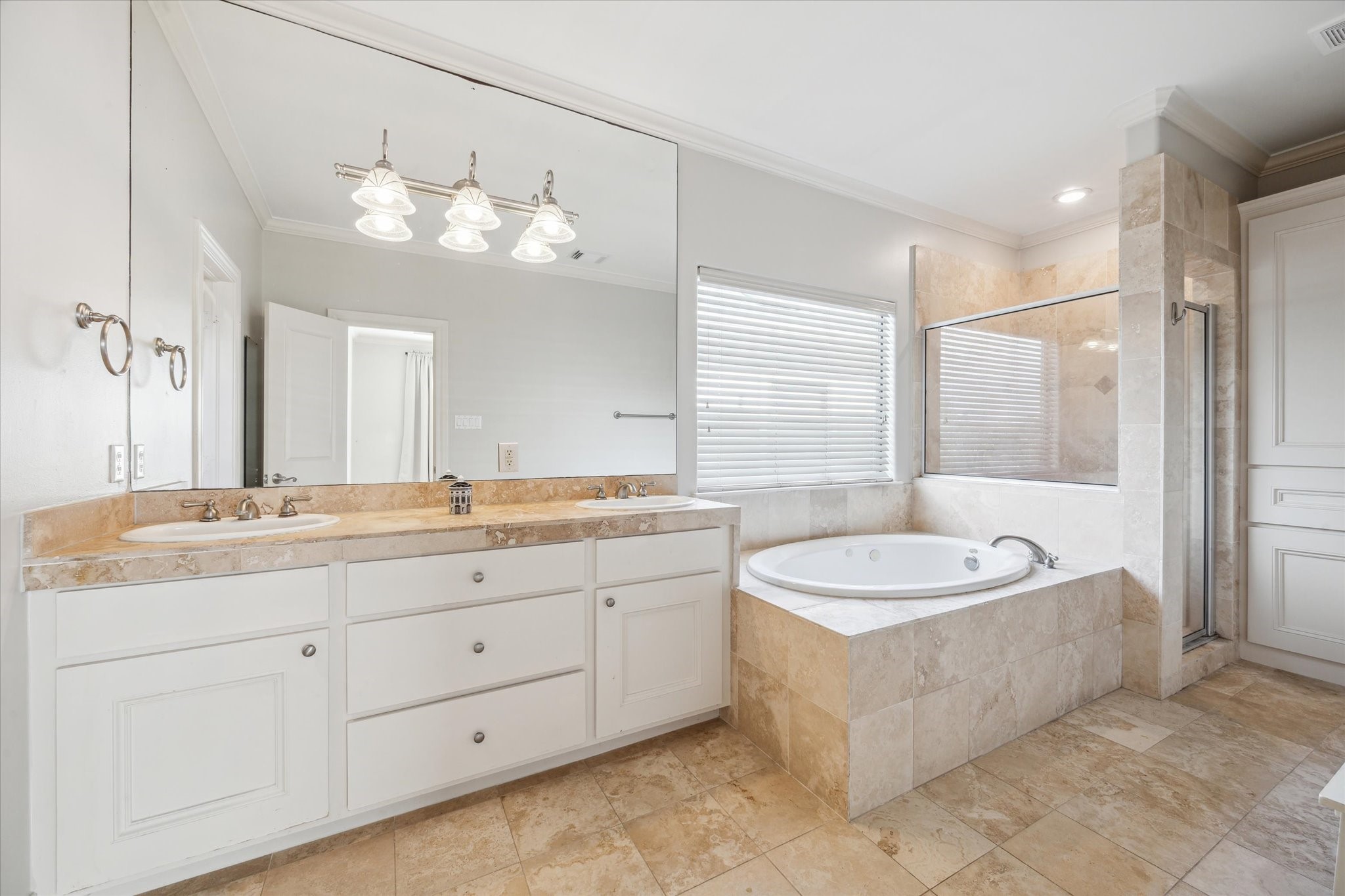 1826 Colquitt Street Houston, TX 77098 - Photo 13 of 23 a spacious bathroom with a granite countertop double vanity sink a mirror and a bathtub