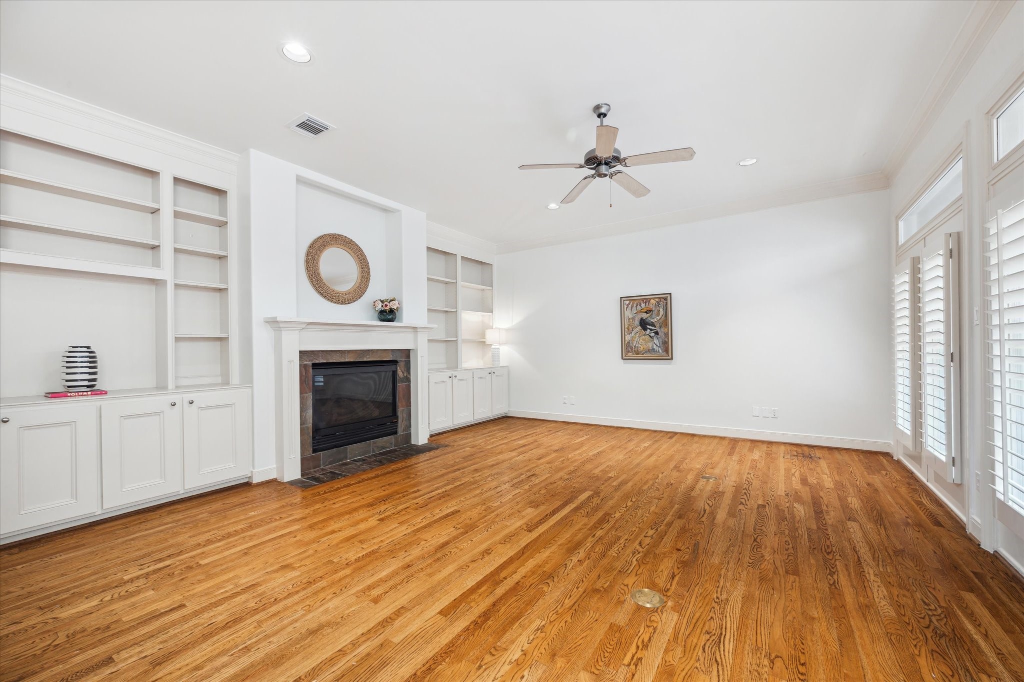 1826 Colquitt Street Houston, TX 77098 - Photo 5 of 23 a view of empty room with wooden floor and fireplace