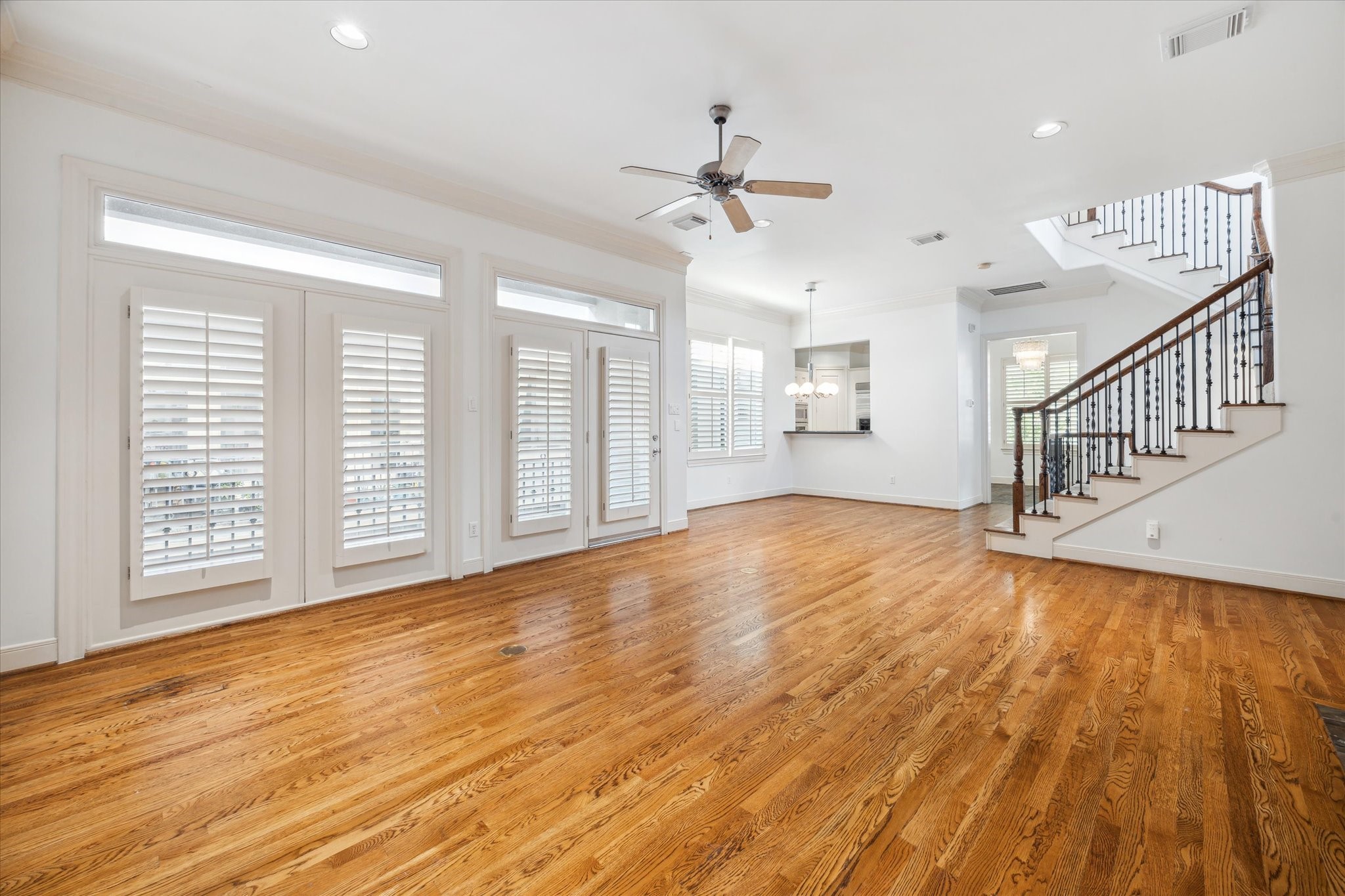 1826 Colquitt Street Houston, TX 77098 - Photo 6 of 23 a view of an empty room with wooden floor and a window