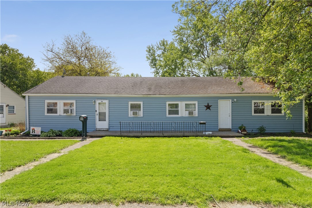 68-70 East Sunset Drive Rittman, OH 44270 - Photo 4 of 49 Light blue siding exterior with a dark shingle roof
