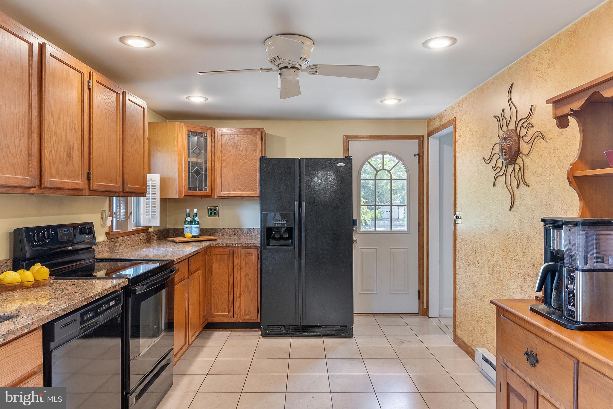 518 Laurel Road Riva, MD 21140 - Photo 7 of 42 a kitchen with stainless steel appliances granite countertop a refrigerator a sink a stove top oven and a refrigerator