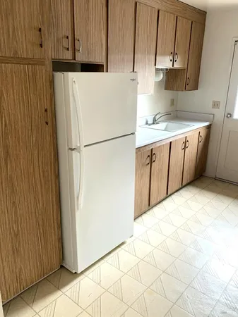 a kitchen with granite countertop a sink stove and cabinets