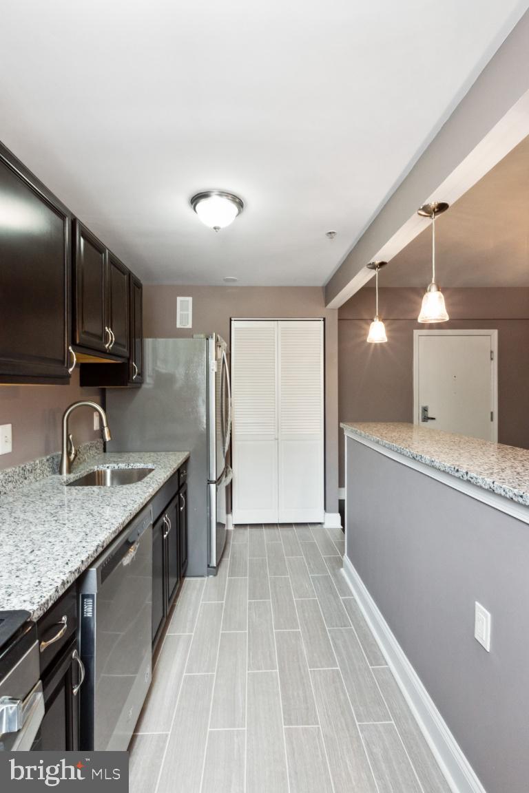 3900 14th Street Northwest, Unit 103 Washington, DC 20011 - Photo 14 of 29 a view of a kitchen with a sink and wooden floor