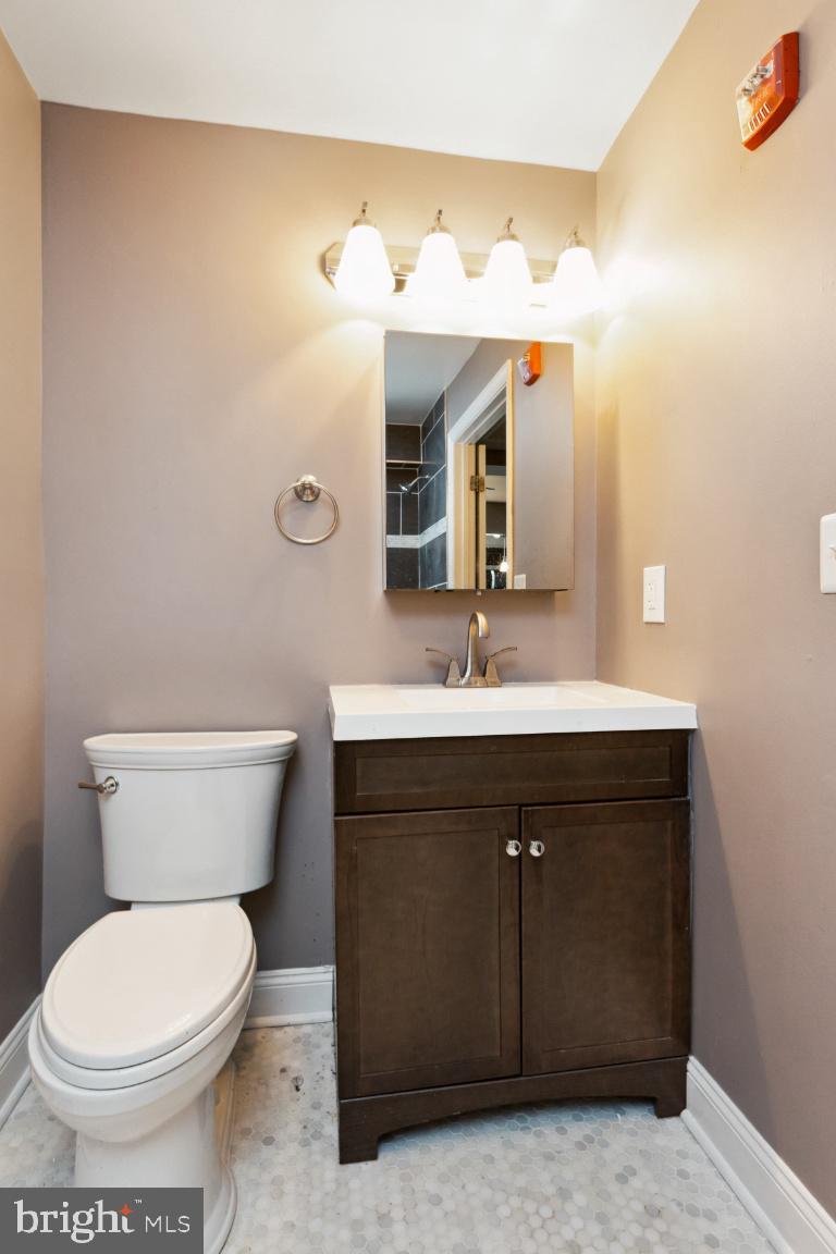 3900 14th Street Northwest, Unit 103 Washington, DC 20011 - Photo 17 of 29 a bathroom with a sink vanity and toilet
