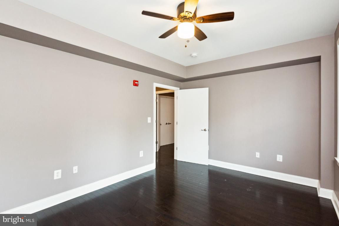 3900 14th Street Northwest, Unit 103 Washington, DC 20011 - Photo 22 of 29 an empty room with wooden floor and windows