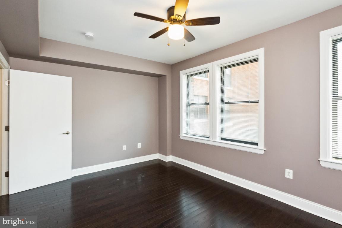 3900 14th Street Northwest, Unit 103 Washington, DC 20011 - Photo 23 of 29 a view of an empty room with wooden floor and a window