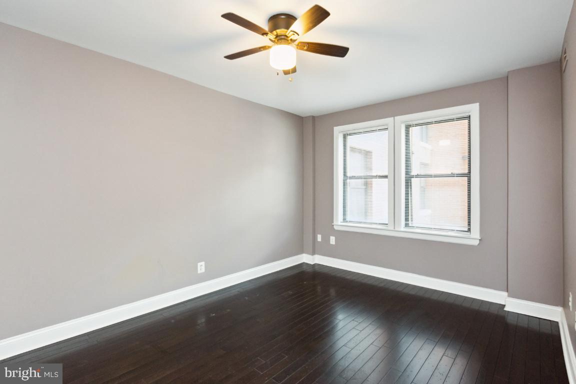 3900 14th Street Northwest, Unit 103 Washington, DC 20011 - Photo 24 of 29 a view of wooden floor and a chandelier fan in a room