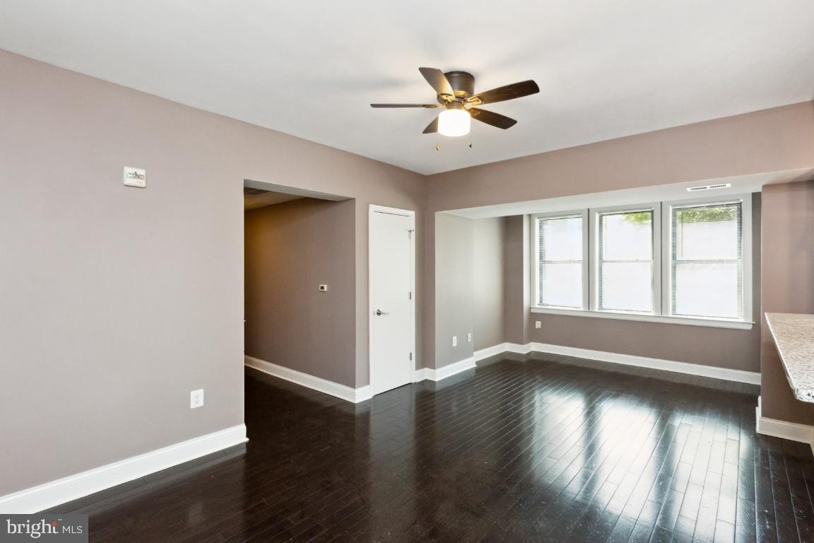 3900 14th Street Northwest, Unit 103 Washington, DC 20011 - Photo 3 of 29 a view of an empty room with wooden floor and a window