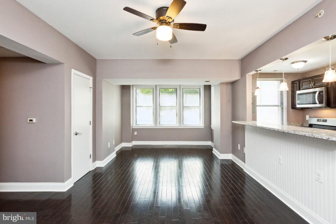 3900 14th Street Northwest, Unit 103 Washington, DC 20011 - Photo 4 of 29 a view of empty room with wooden floor and fan