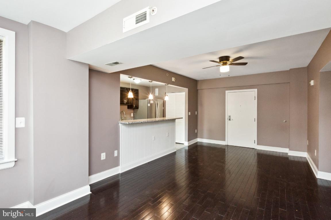 3900 14th Street Northwest, Unit 103 Washington, DC 20011 - Photo 6 of 29 a view of an empty room with wooden floor and a window