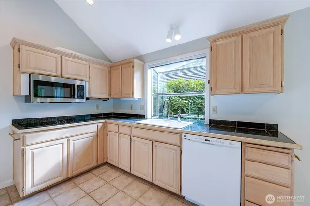 a kitchen with white cabinets and a stove top oven