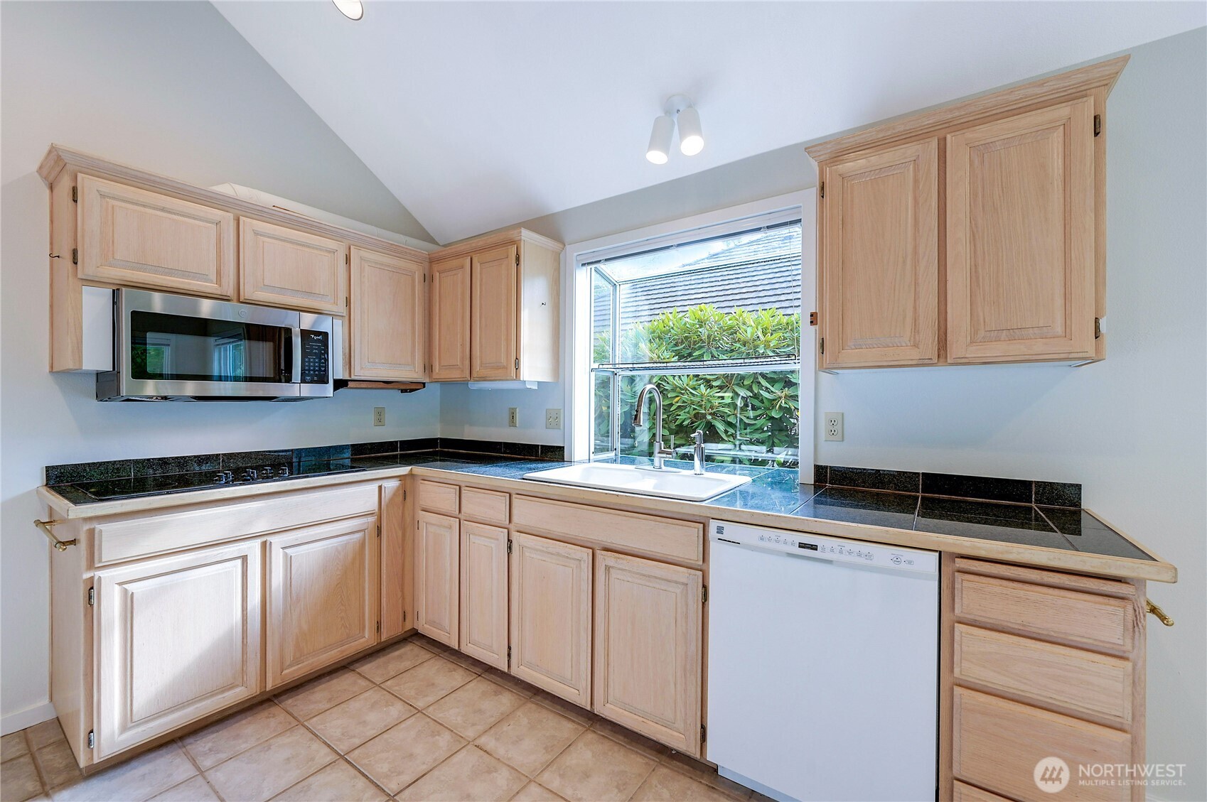41 South Keel Way, Unit B Port Ludlow, WA 98365 - Photo 14 of 39 a kitchen with white cabinets and a stove top oven