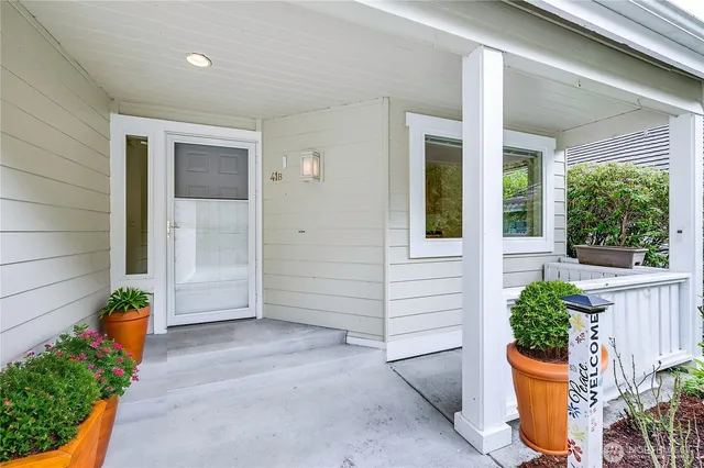 front view of a house with potted plants