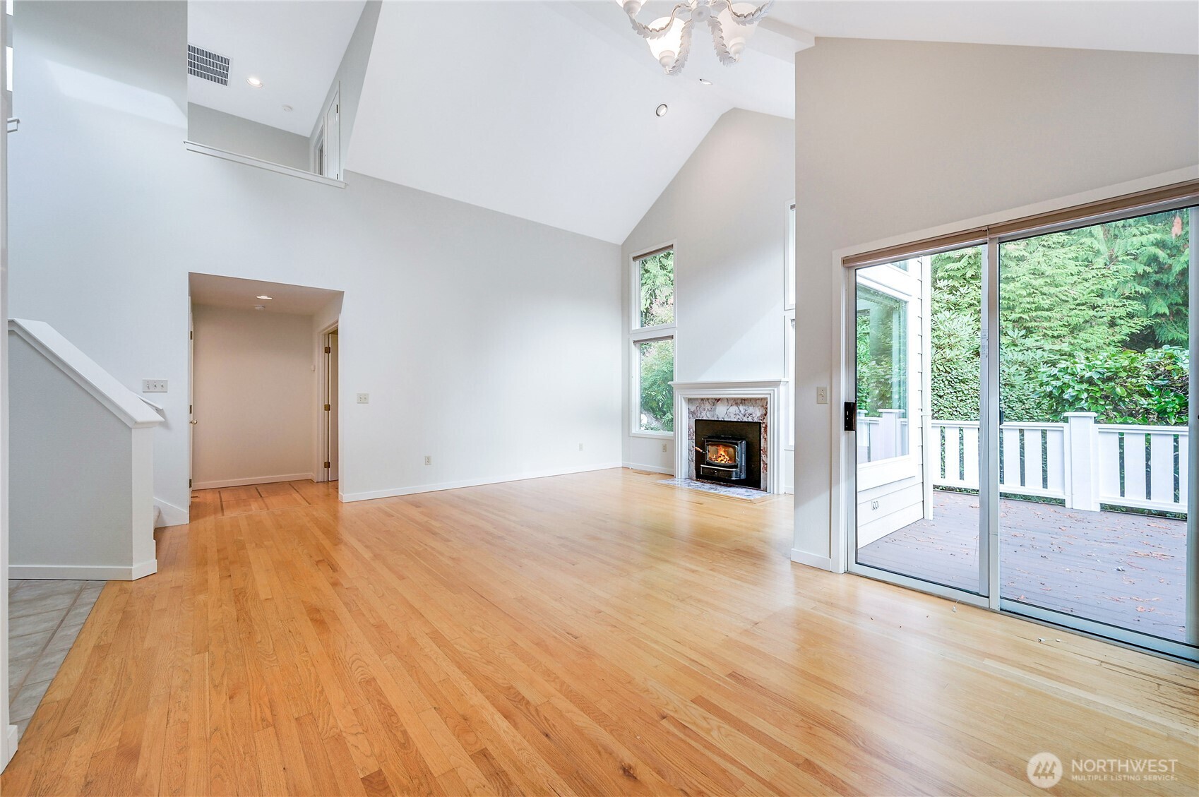 41 South Keel Way, Unit B Port Ludlow, WA 98365 - Photo 22 of 39 a view of empty room with wooden floor and fireplace
