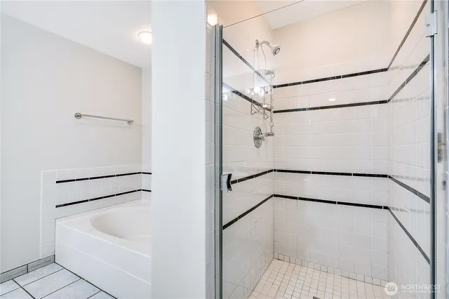 a bathroom with a white bath tub and a shower