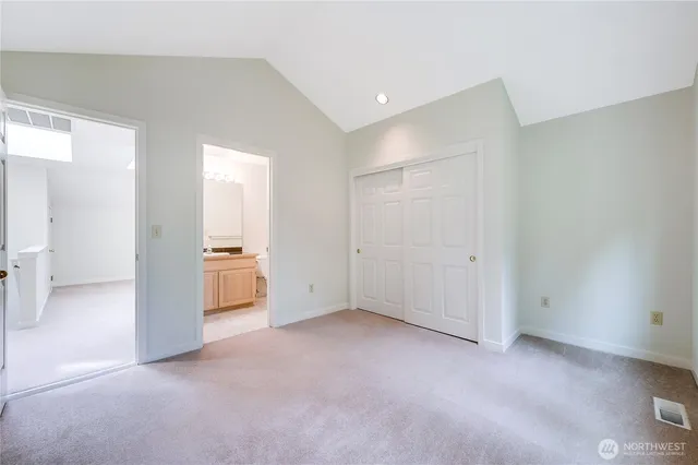 a bathroom with a granite countertop sink toilet a mirror and shower