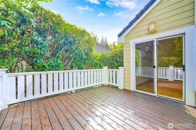 a view of backyard with wooden floor and fence