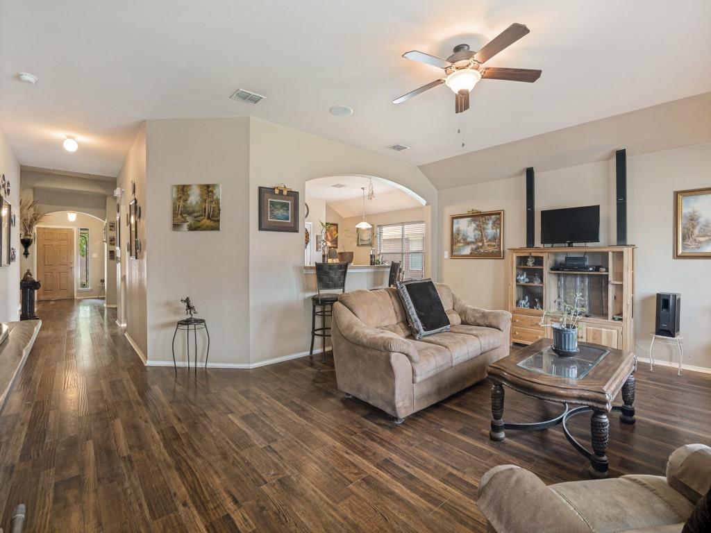 119 Robin Lane Forney, TX 75126 - Photo 7 of 27 Open-concept living space featuring wood-finish flooring, a ceiling fan with integrated lighting, and vaulted ceilings