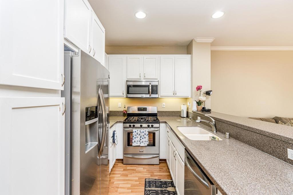 a kitchen with a sink stove and refrigerator