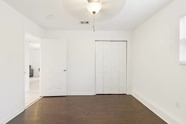 a view of an empty room with closet