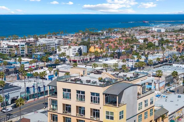 a living room with furniture pool table and potted plants