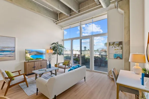 a living room with furniture and a large window