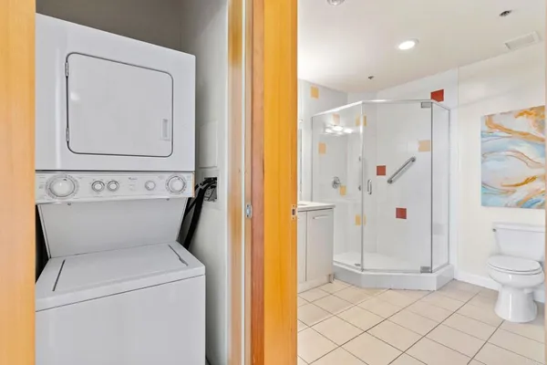 a view of washer and dryer with bathroom