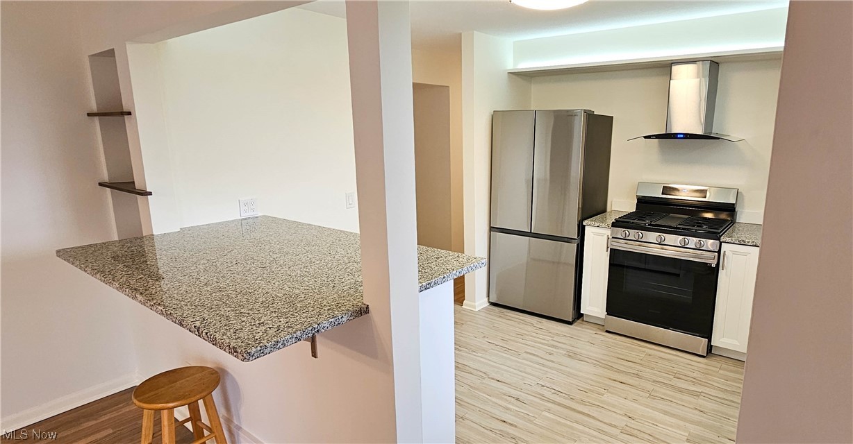 19755 Upper Terrace Road Euclid, OH 44117 - Photo 4 of 38 New kitchen with granite counters and newer Samsung stainless steel appliances and luxury vinyl tile flooring.