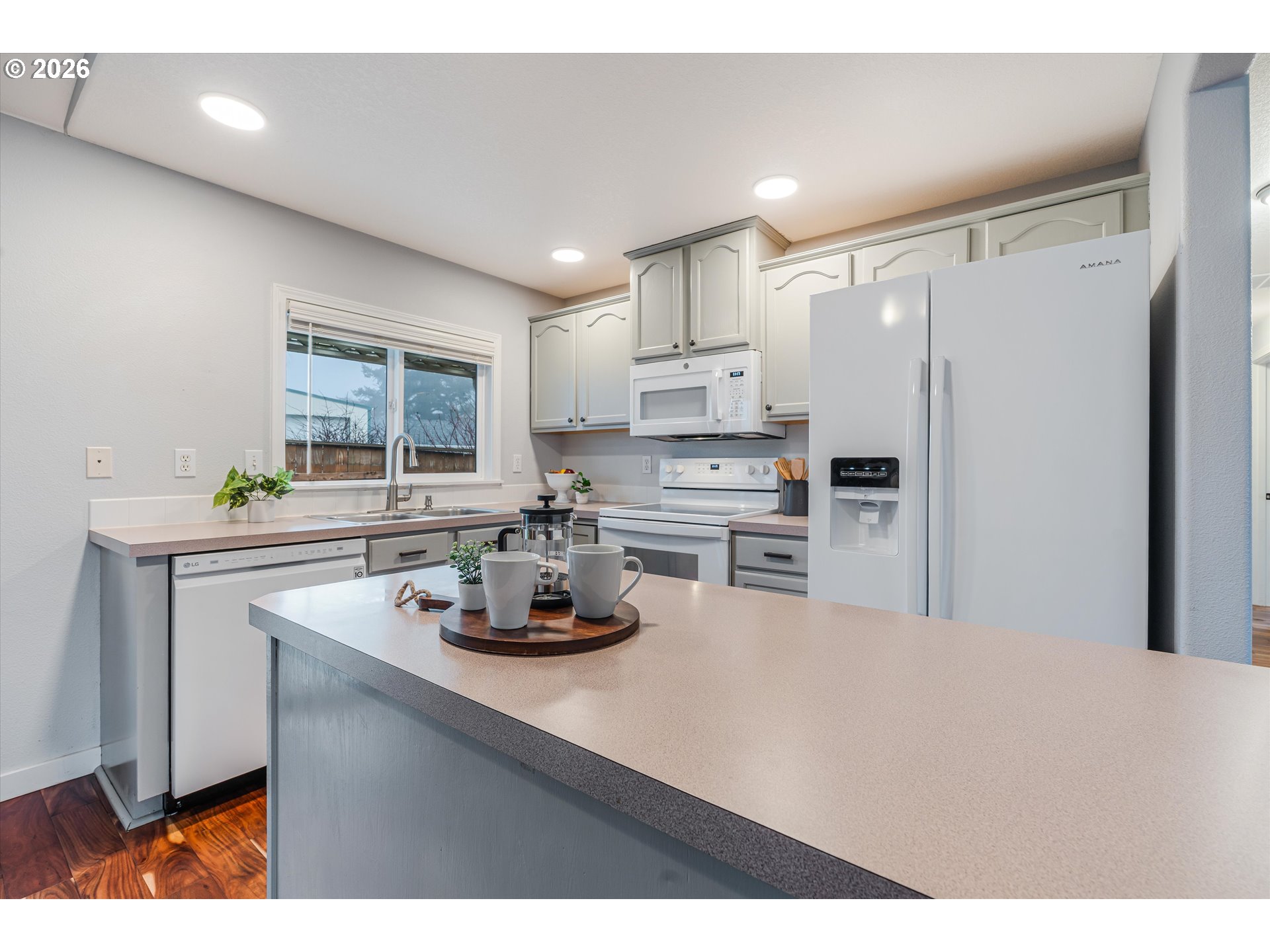 1615 Lilly Court Newberg, OR 97132 - Photo 11 of 30 a kitchen with a refrigerator a stove a sink a counter space and cabinets