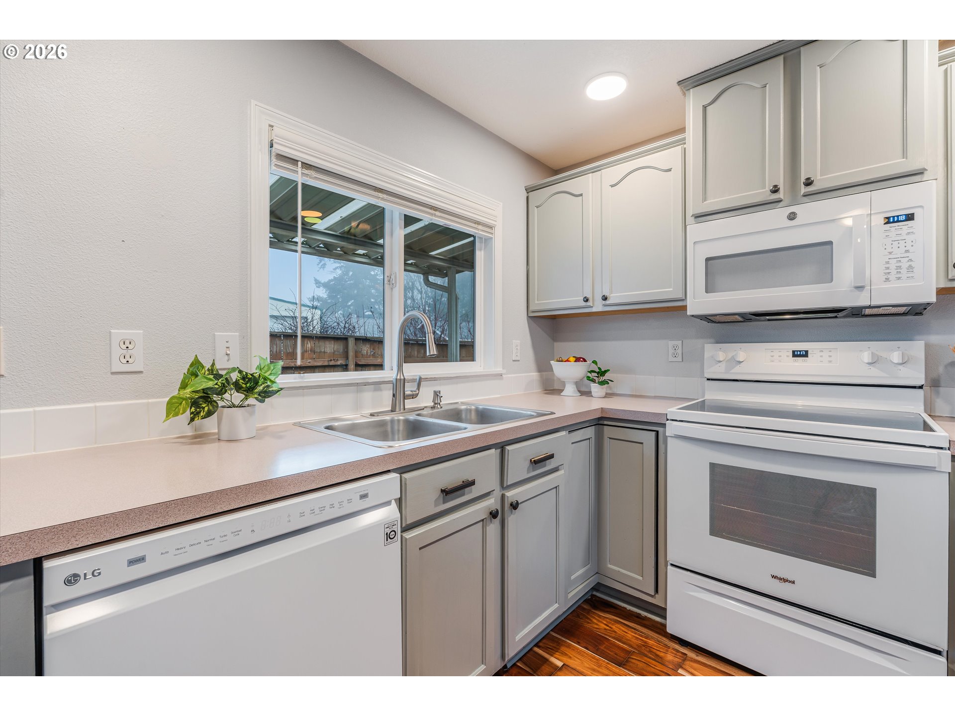1615 Lilly Court Newberg, OR 97132 - Photo 12 of 30 a kitchen with cabinets stainless steel appliances a sink and a window