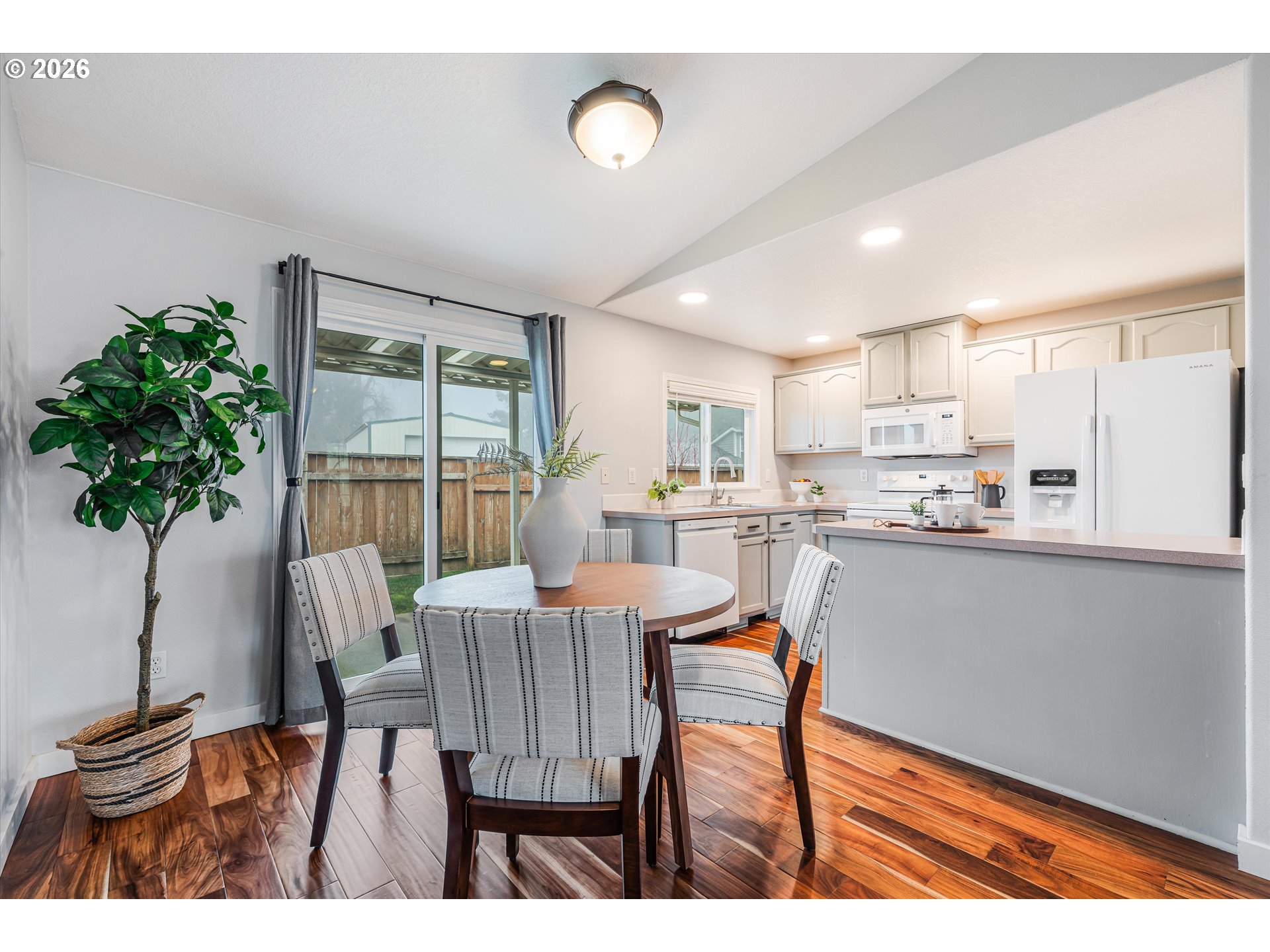 1615 Lilly Court Newberg, OR 97132 - Photo 8 of 30 a view of a dining room with furniture and a potted plant