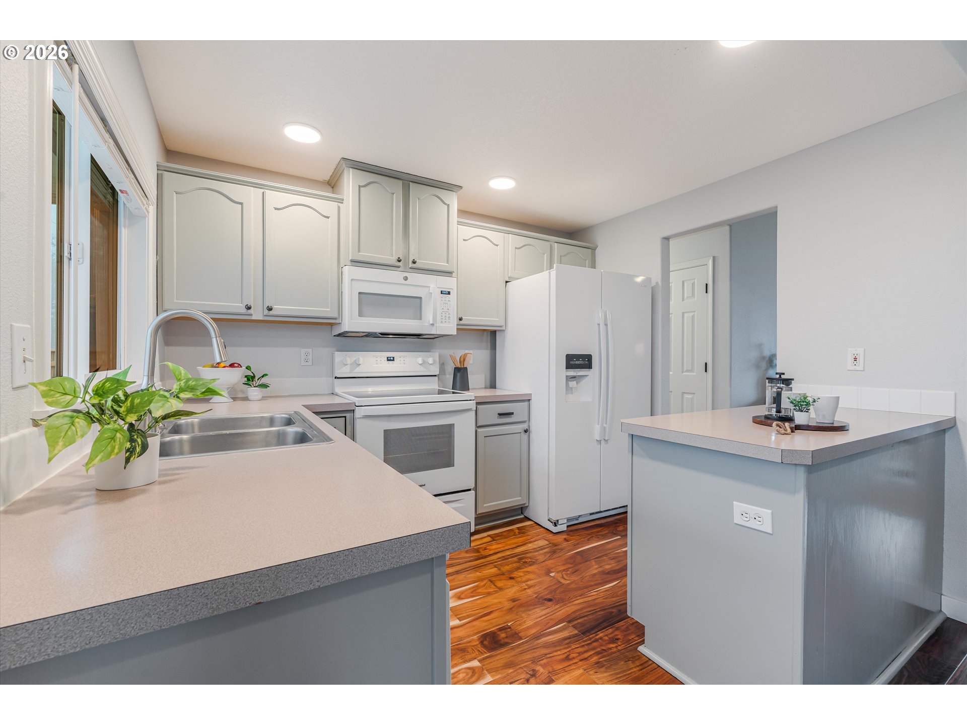1615 Lilly Court Newberg, OR 97132 - Photo 10 of 30 a kitchen with white cabinets and refrigerator