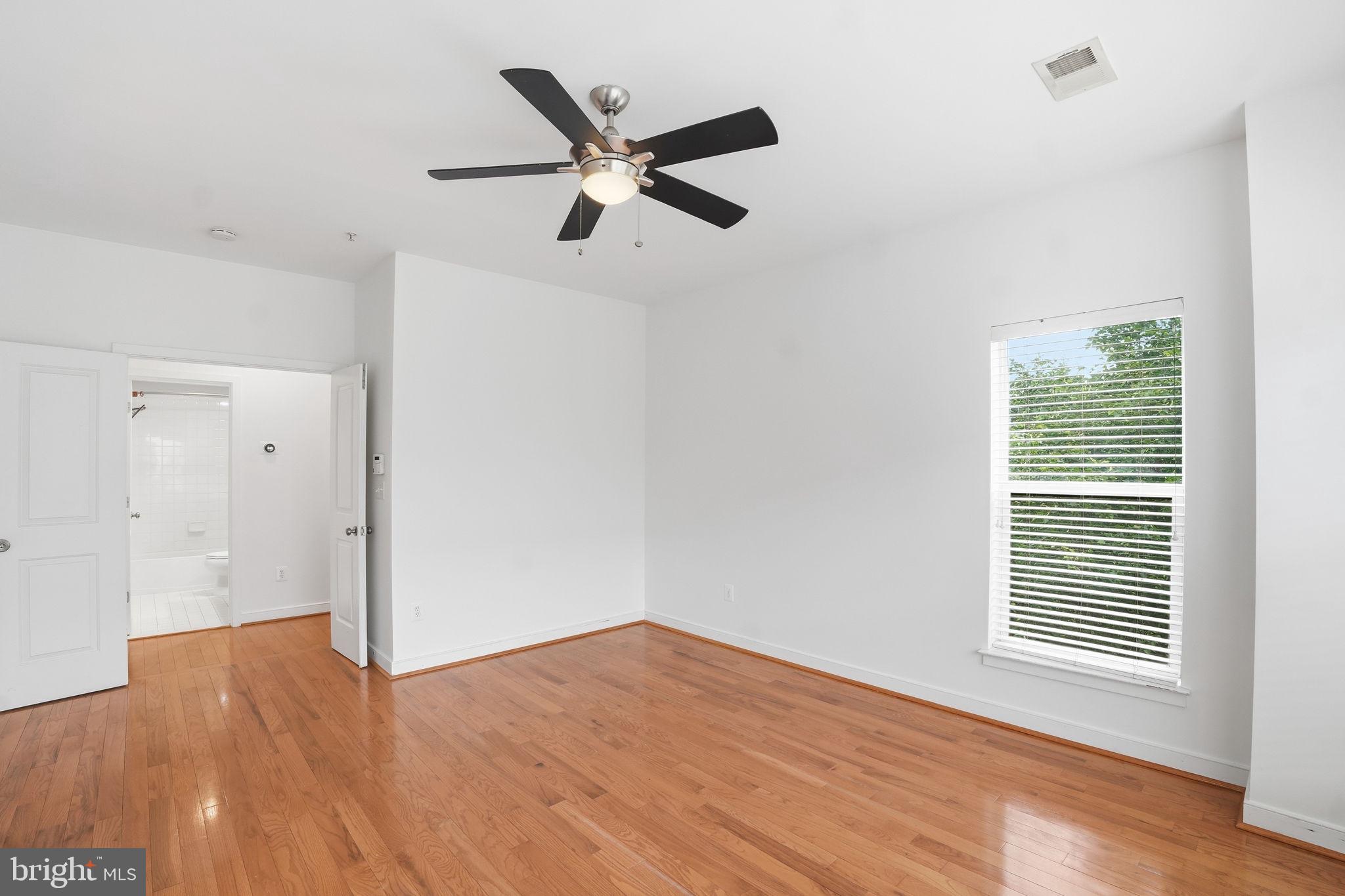 5610 Lustine Street Hyattsville, MD 20781 - Photo 14 of 36 Bright and airy room with hardwood floors.