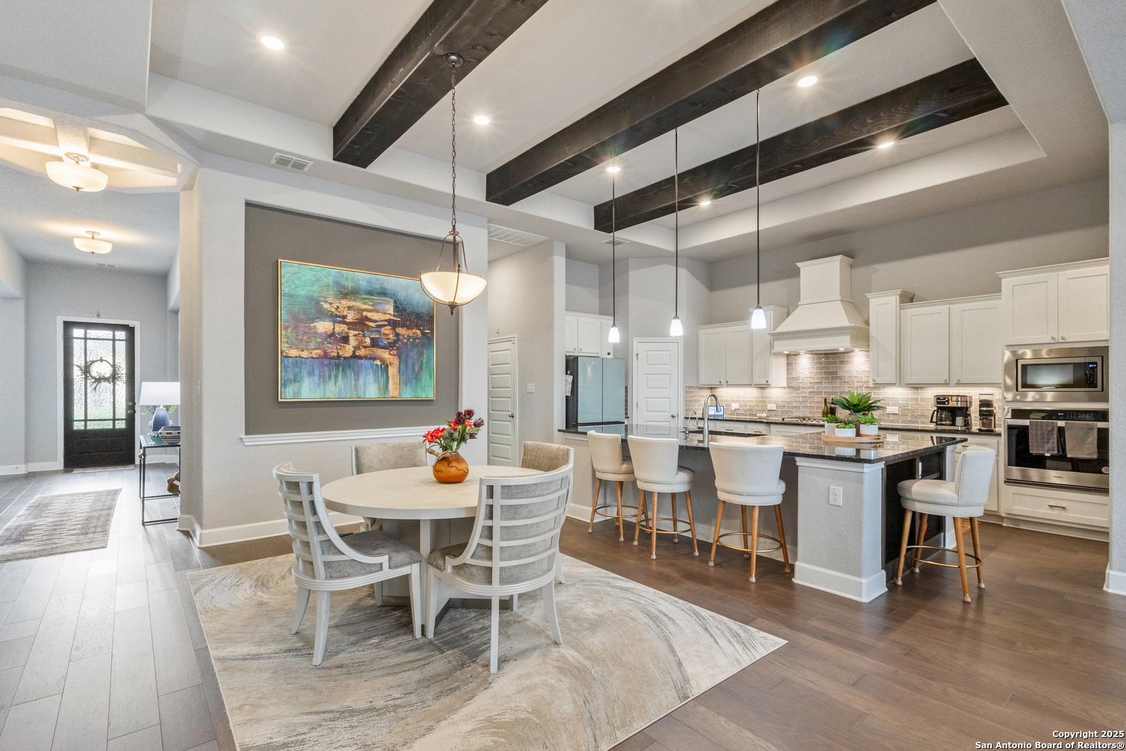 28502 Colares Way San Antonio, TX 78260 - Photo 9 of 38 a dining room with stainless steel appliances kitchen island granite countertop a dining table chairs and view of living room