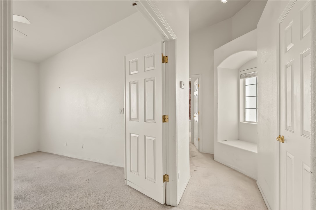2853 Winchester Road Bullhead City, AZ 86442 - Photo 6 of 40 This room features a vaulted ceiling, a ceiling fan, and carpeted flooring