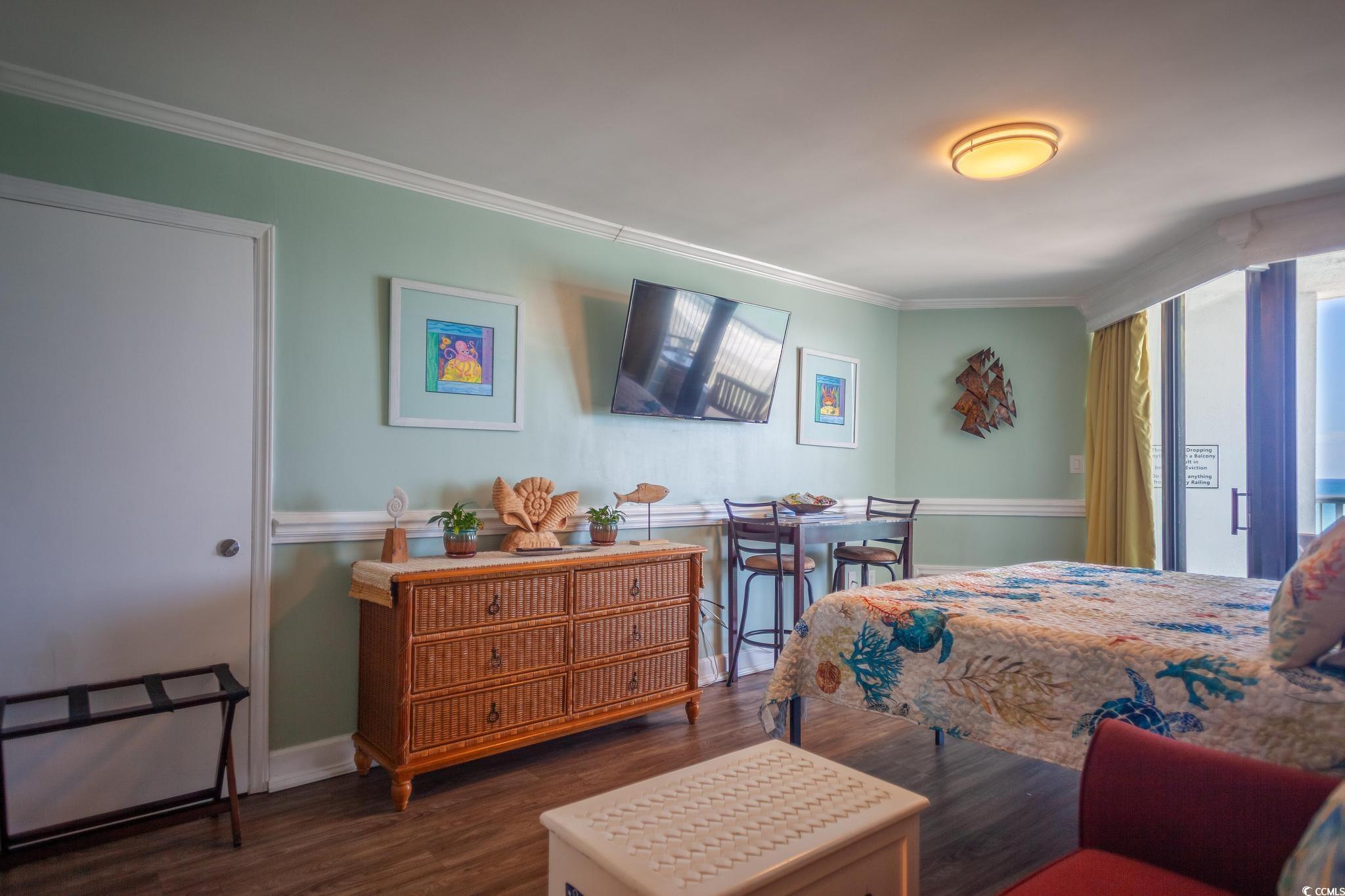 9550 Shore Drive, Unit 1728 Myrtle Beach, SC 29572 - Photo 12 of 36 Bedroom featuring dark wood-style floors and crown molding