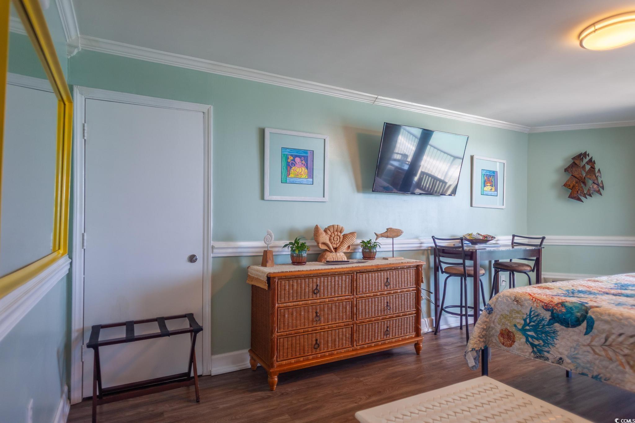 9550 Shore Drive, Unit 1728 Myrtle Beach, SC 29572 - Photo 13 of 36 Bedroom featuring crown molding and dark wood-type flooring