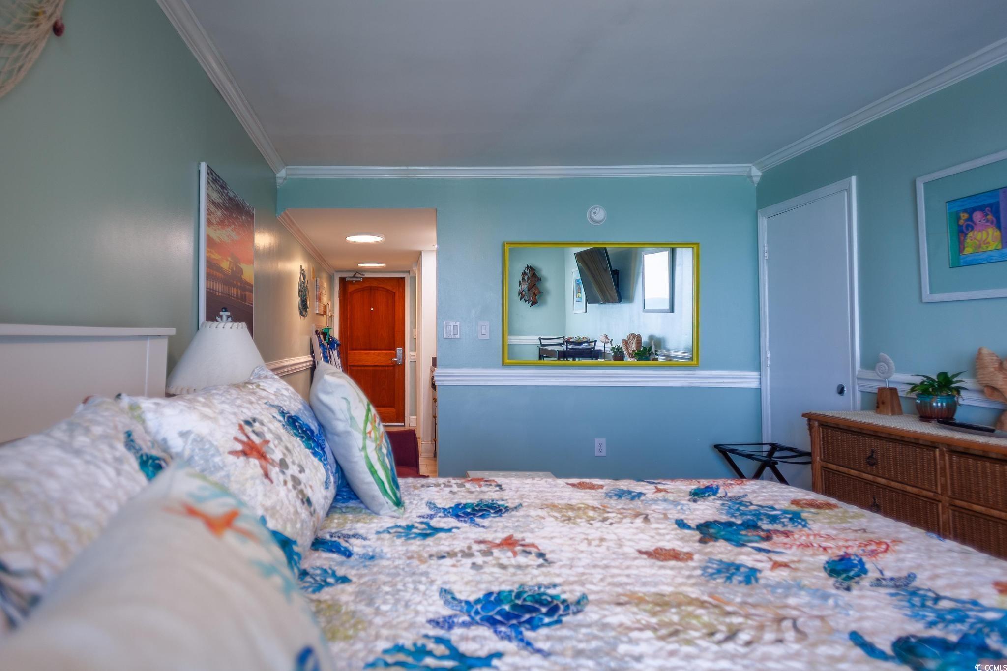 9550 Shore Drive, Unit 1728 Myrtle Beach, SC 29572 - Photo 15 of 36 Bedroom featuring crown molding