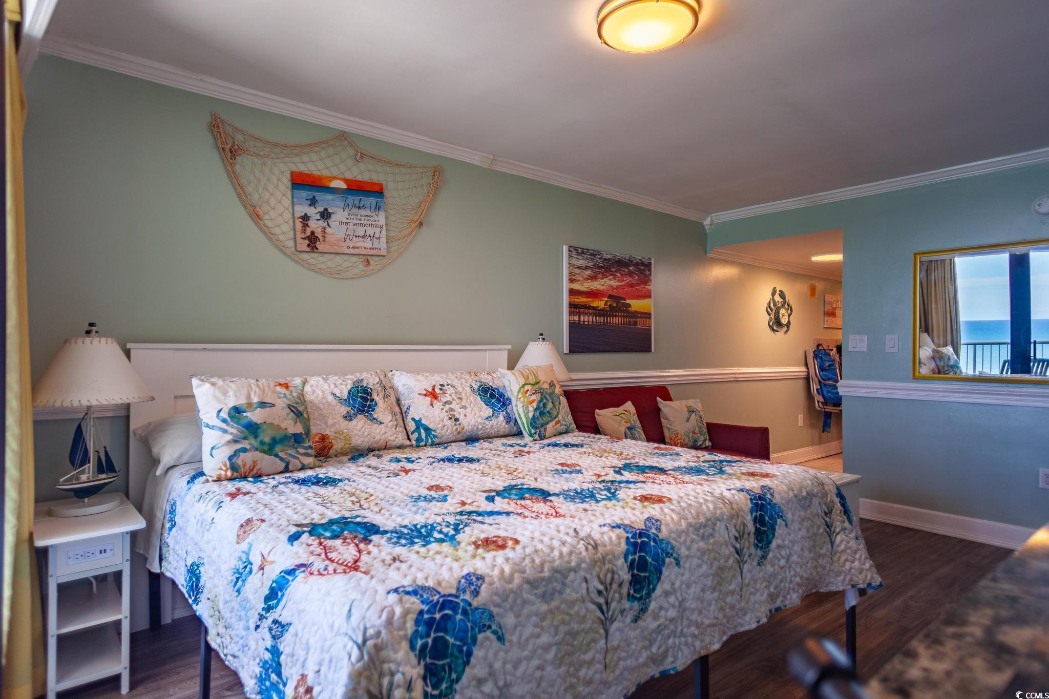 9550 Shore Drive, Unit 1728 Myrtle Beach, SC 29572 - Photo 16 of 36 Bedroom featuring dark wood finished floors and crown molding