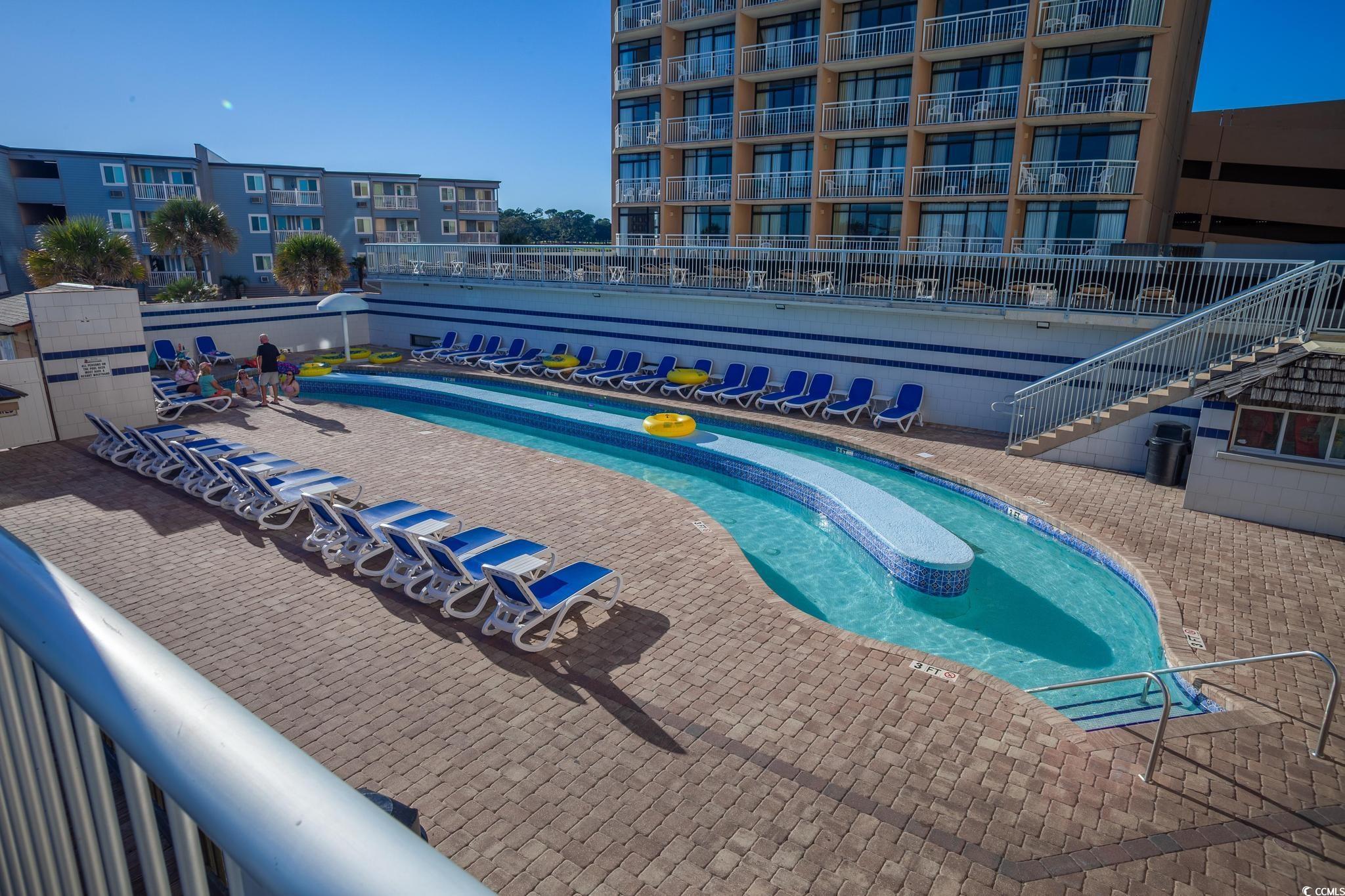 9550 Shore Drive, Unit 1728 Myrtle Beach, SC 29572 - Photo 25 of 36 Community pool with view of water and beach