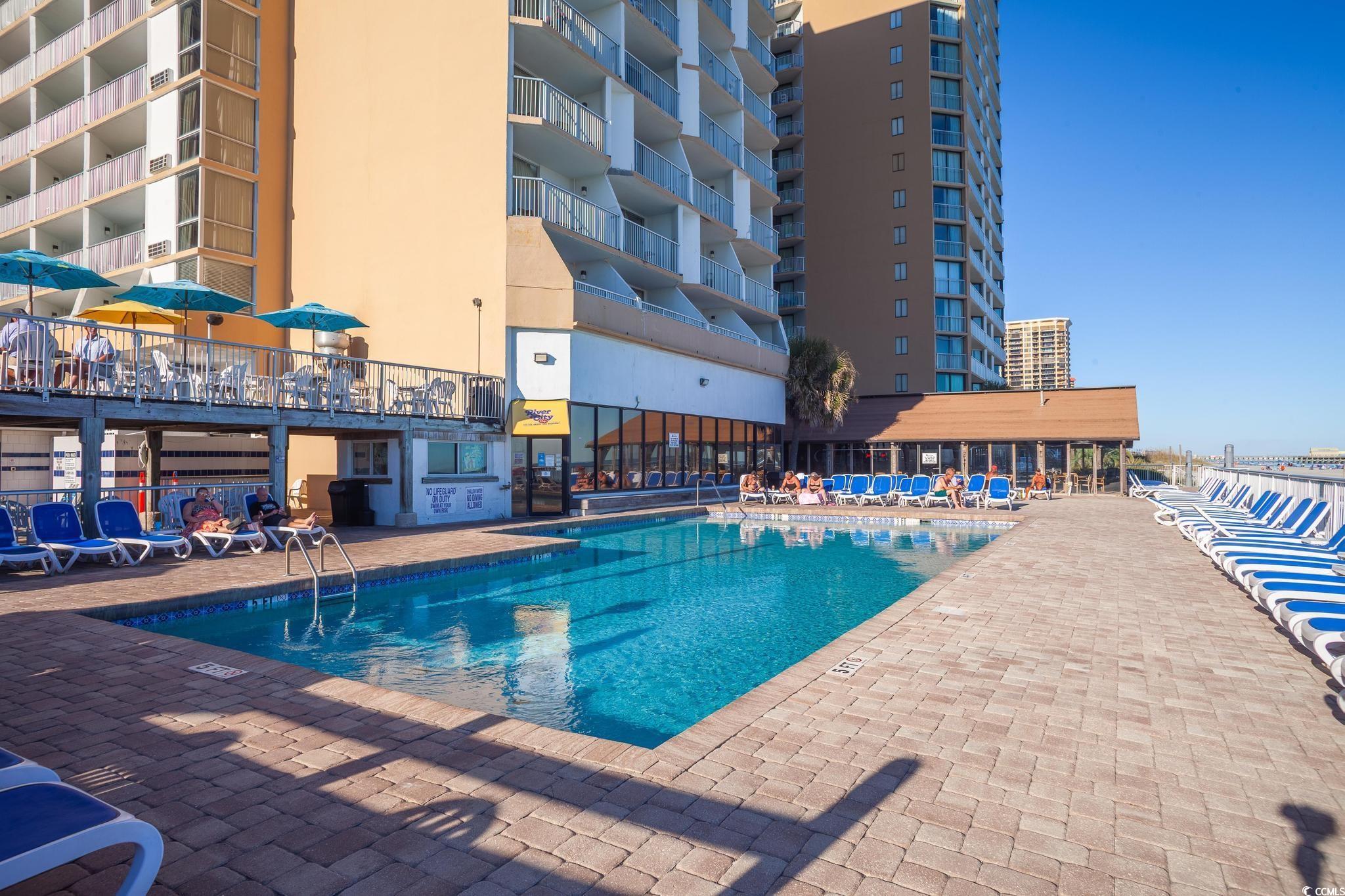 9550 Shore Drive, Unit 1728 Myrtle Beach, SC 29572 - Photo 27 of 36 Wooden deck featuring outdoor dining area